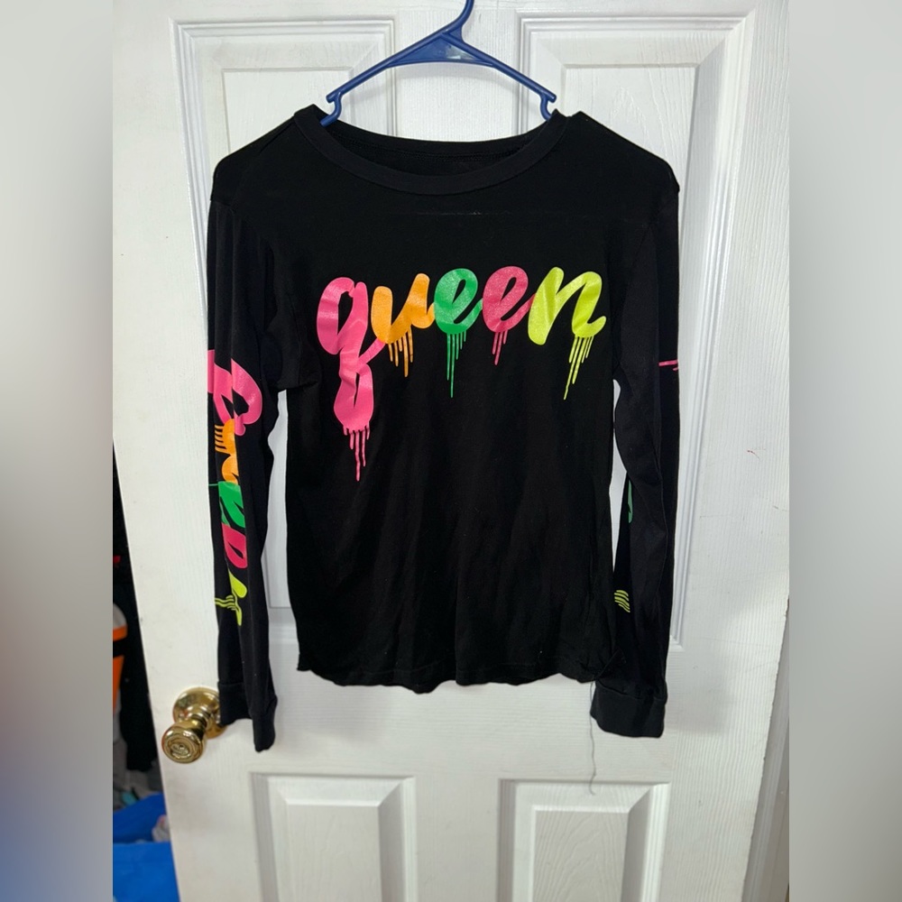 Women’s black long sleeve tee with queen drip print in neon on shirt and sleeve